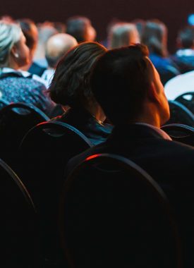 People listening to a speaker at a conference